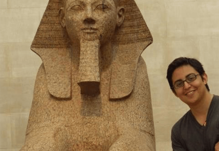 MBA alumnus luis otrtiz posing with a sphinx statue